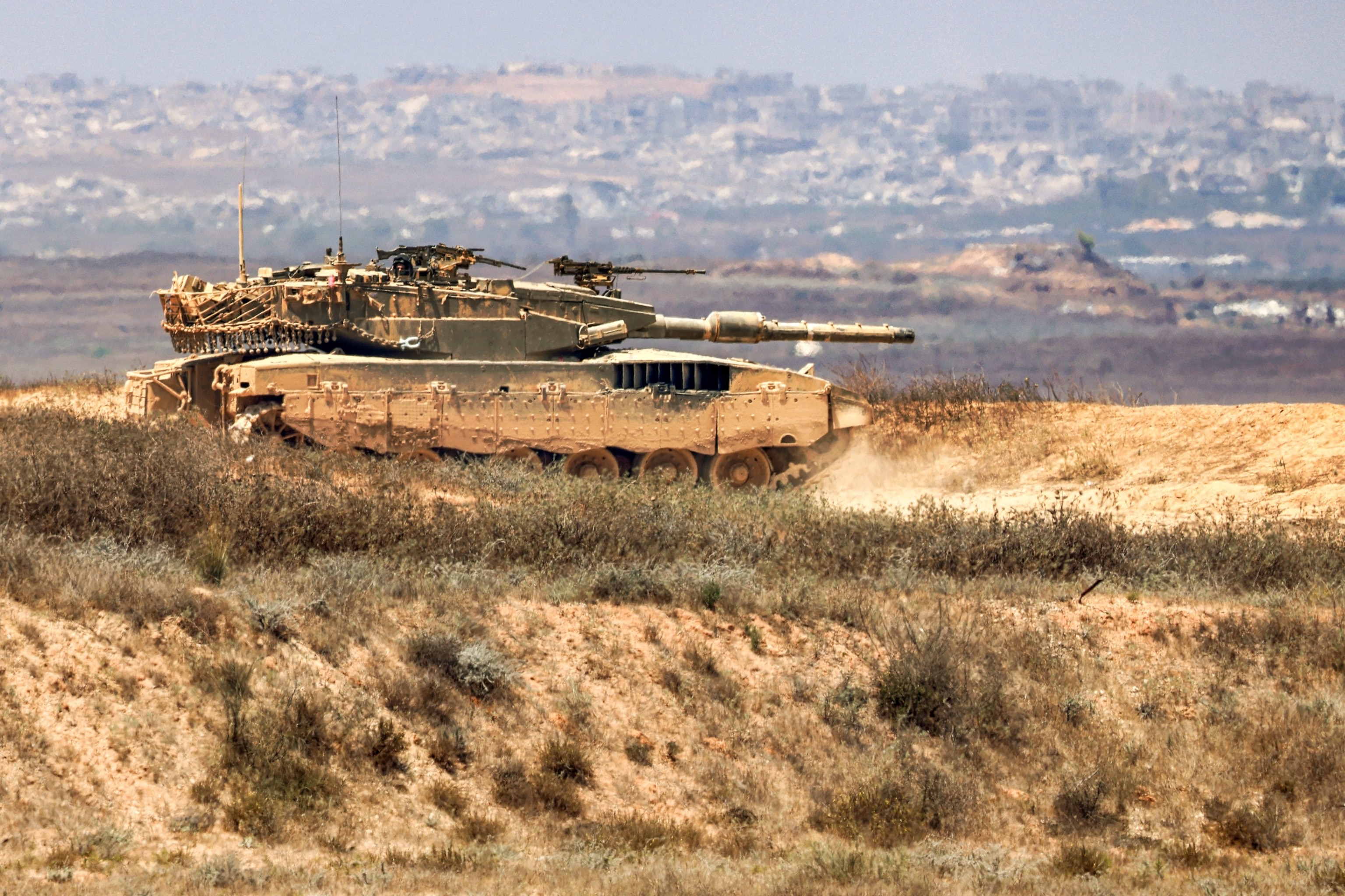 PHOTO: An Israeli army main battle tank moves along an area near the border with the Gaza Strip and southern Israel, July 2, 2024, amid the ongoing conflict in the Palestinian territory between Israel and Hamas.